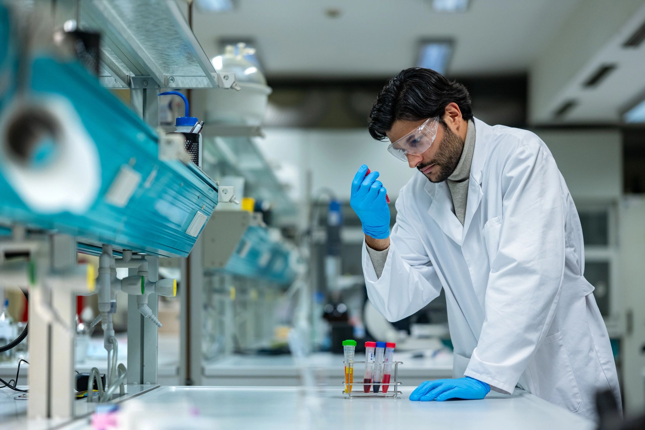 Scientist evaluating plant-based extracts in a modern laboratory